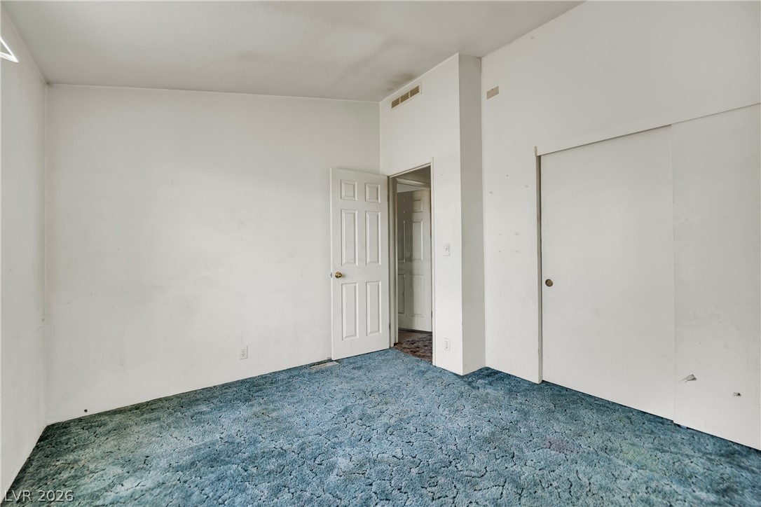 4361 Maple Road Pahrump, NV 89048 - Photo 26 of 46 A modest bedroom features durable carpet and ample storage with sliding closet doors.