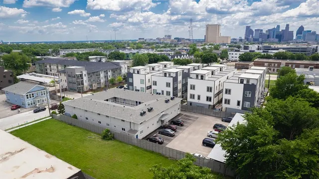 an aerial view of a house with a garden and trees