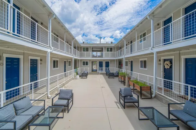 a view of a building with outdoor seating