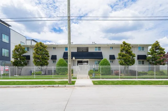 a view of a house with a patio and a yard