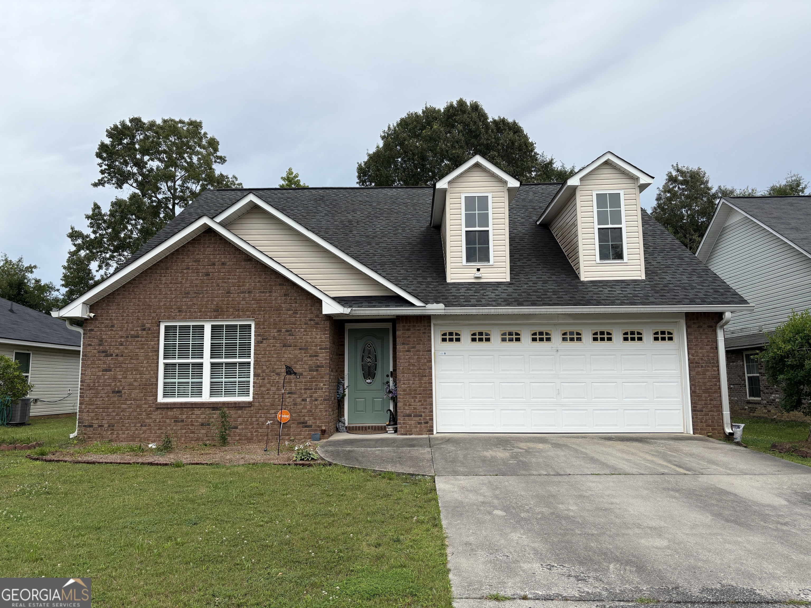 a front view of a house with a yard and garage