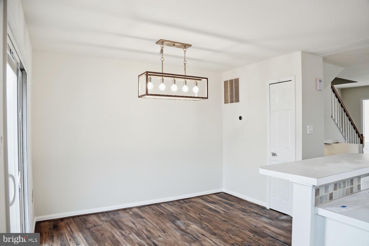 8461 Tackhouse Loop Gainesville, VA 20155 - Photo 2 of 10 a view of a room with a sink and wooden floor