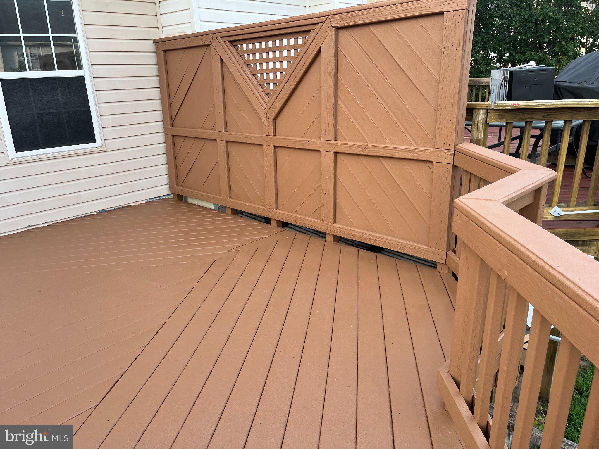 8461 Tackhouse Loop Gainesville, VA 20155 - Photo 10 of 10 a view of a balcony with wooden floor and fence