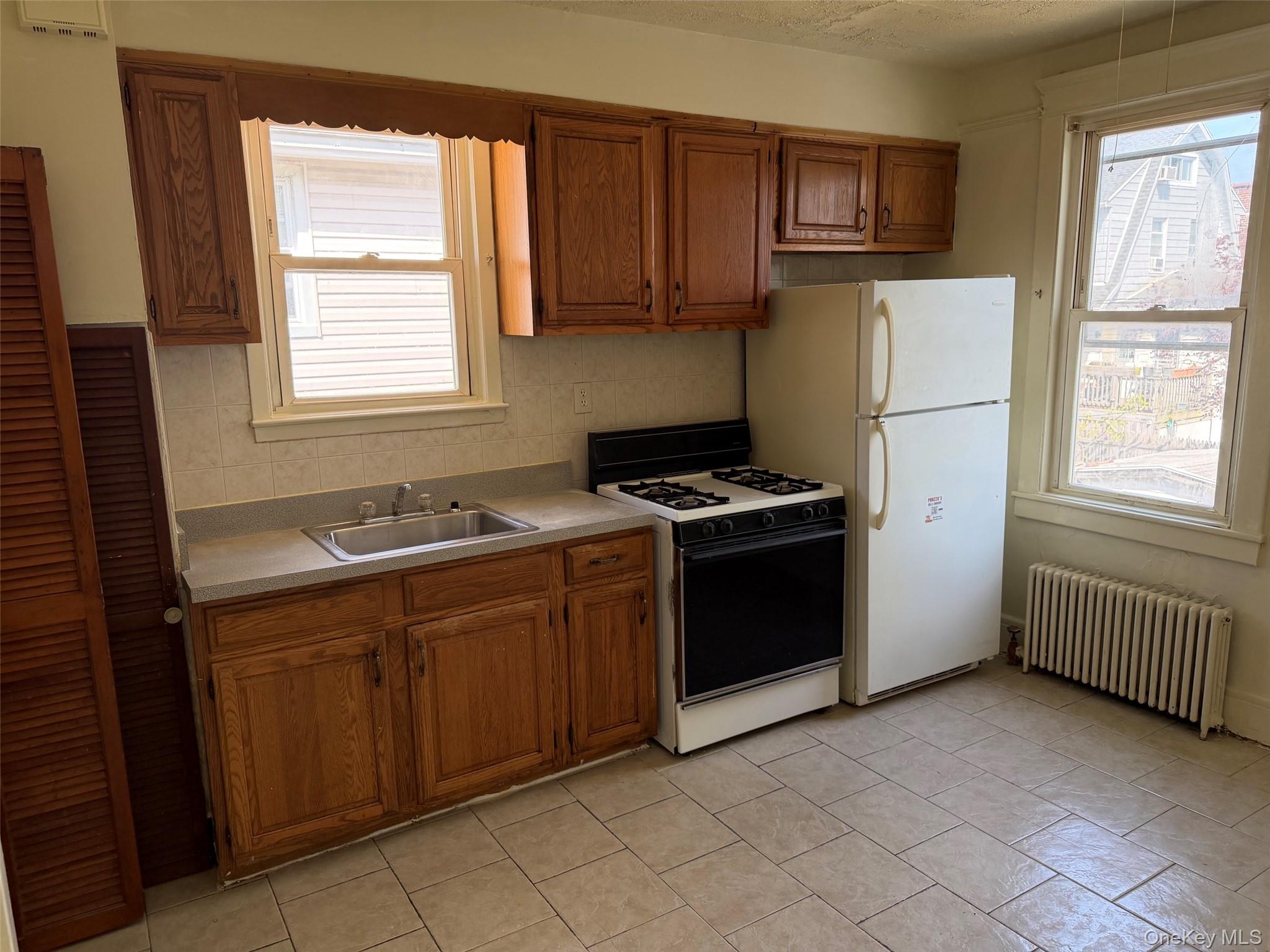 2941 Middletown Road Bronx, NY 10461 - Photo 12 of 31 a kitchen with stainless steel appliances a refrigerator sink and cabinets