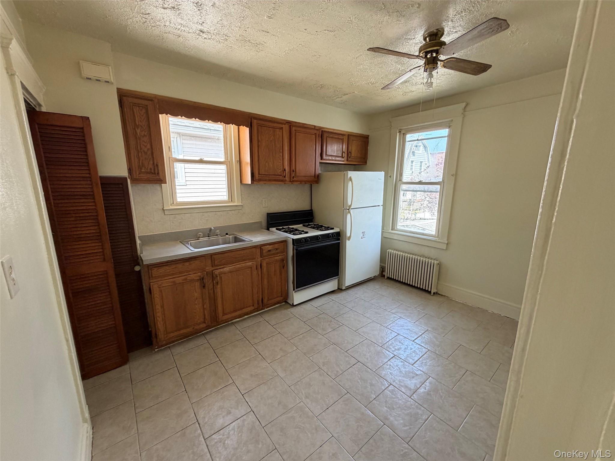 2941 Middletown Road Bronx, NY 10461 - Photo 13 of 31 a kitchen with stainless steel appliances granite countertop a stove a sink and a refrigerator