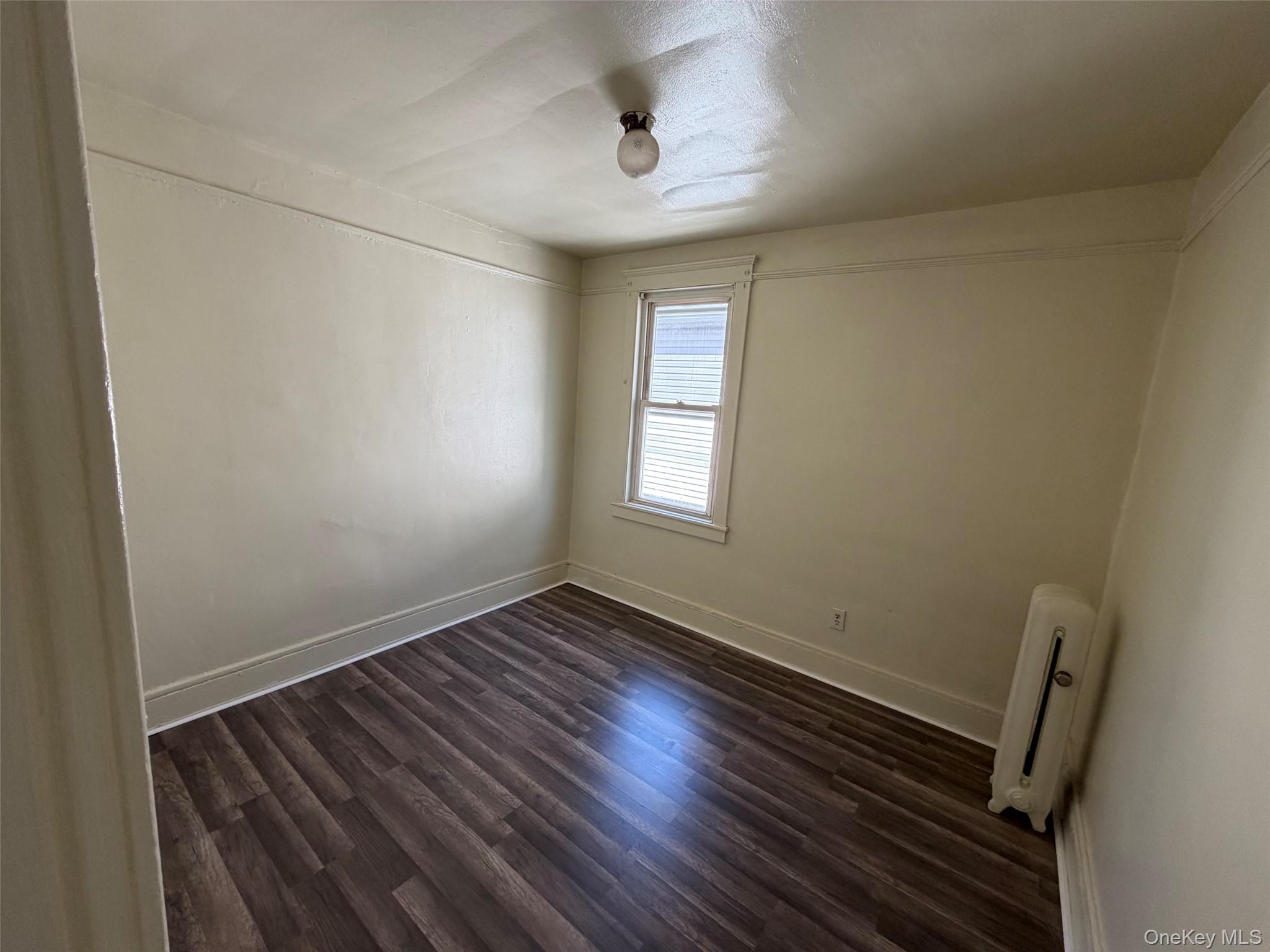2941 Middletown Road Bronx, NY 10461 - Photo 15 of 31 a view of an empty room with wooden floor and a window