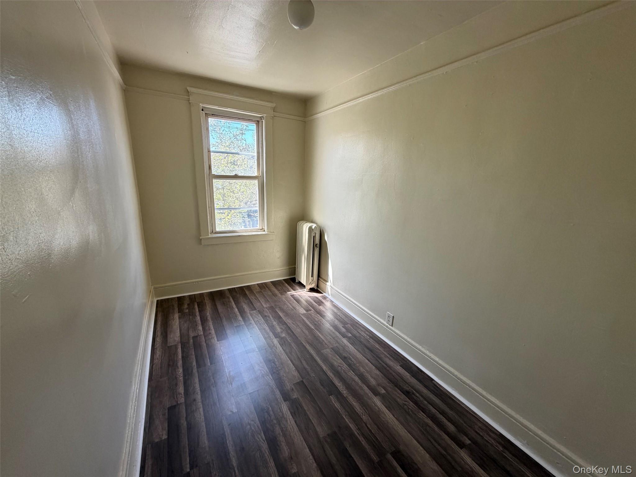 2941 Middletown Road Bronx, NY 10461 - Photo 18 of 31 a view of an empty room with wooden floor and a window
