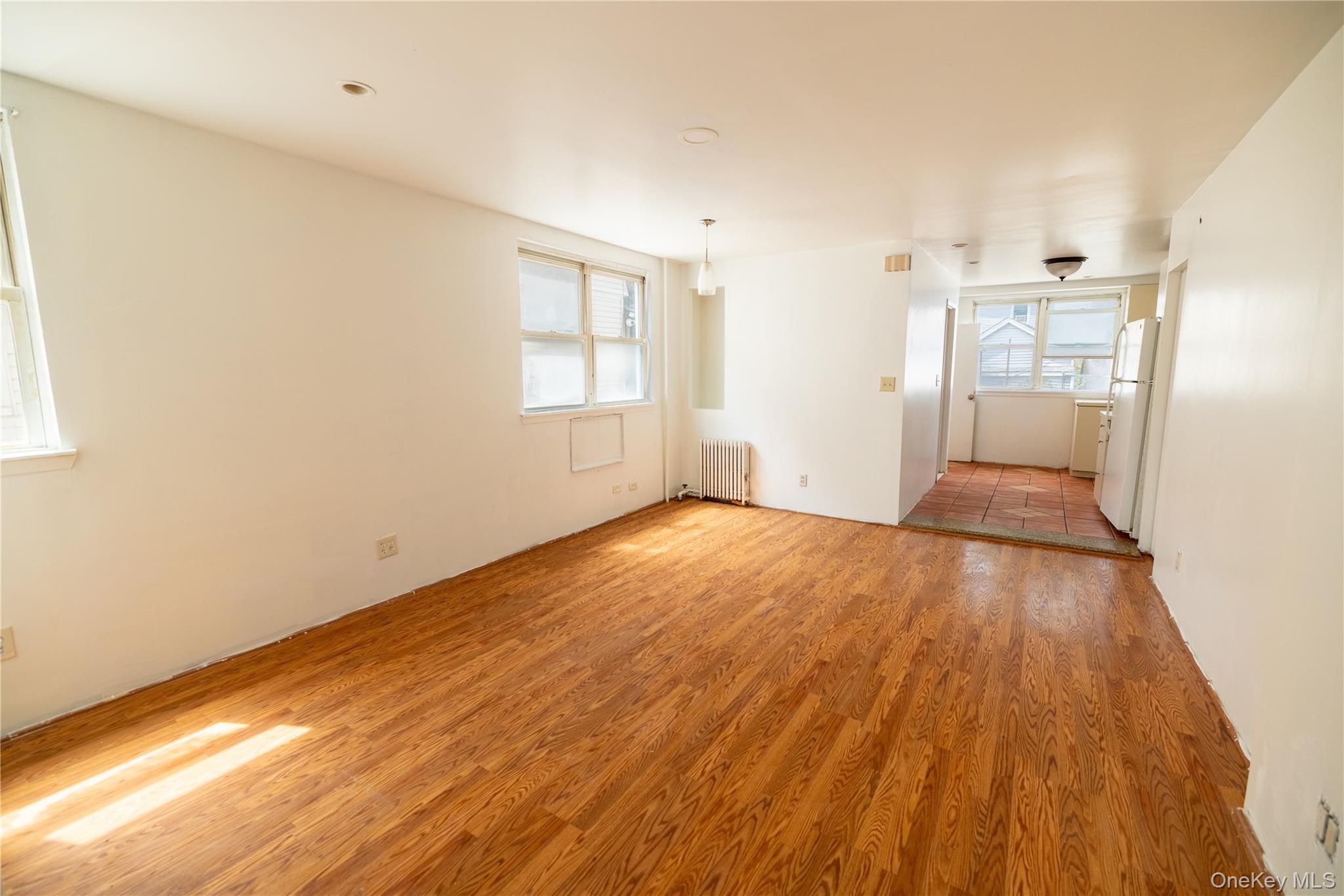 2941 Middletown Road Bronx, NY 10461 - Photo 3 of 31 a view of empty room with wooden floor and fan