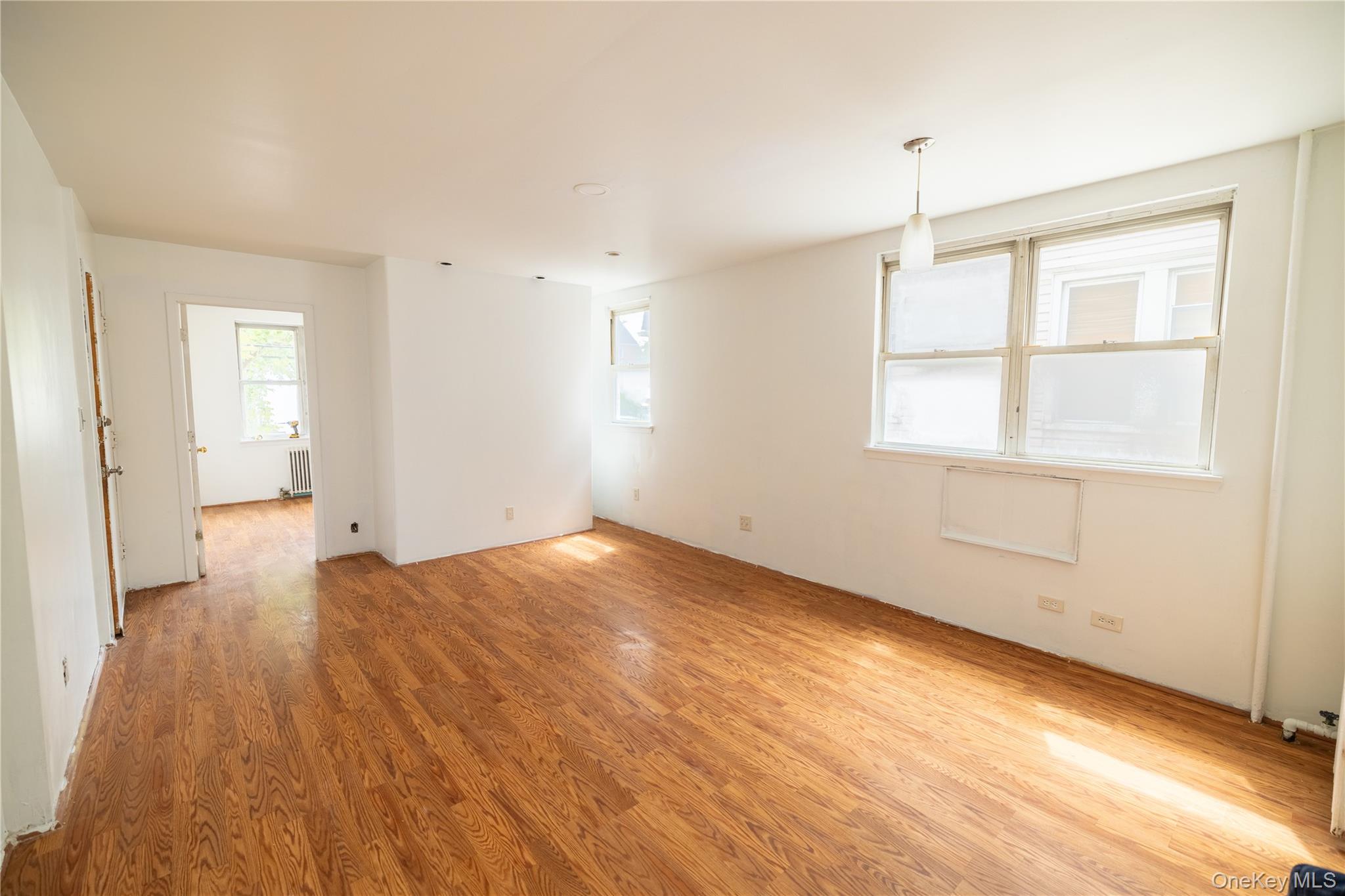2941 Middletown Road Bronx, NY 10461 - Photo 4 of 31 an empty room with wooden floor and windows