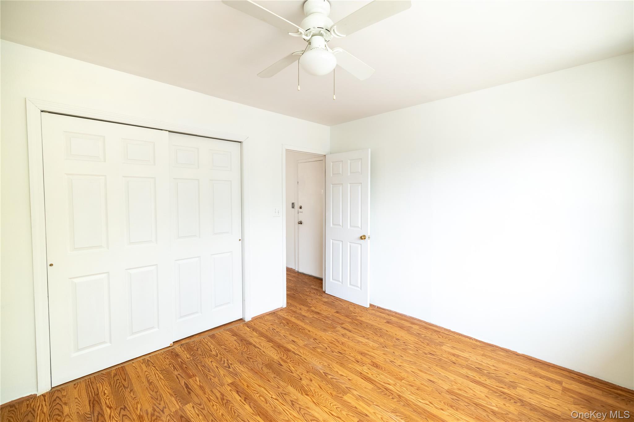 2941 Middletown Road Bronx, NY 10461 - Photo 6 of 31 a bedroom with a bed and a chandelier fan