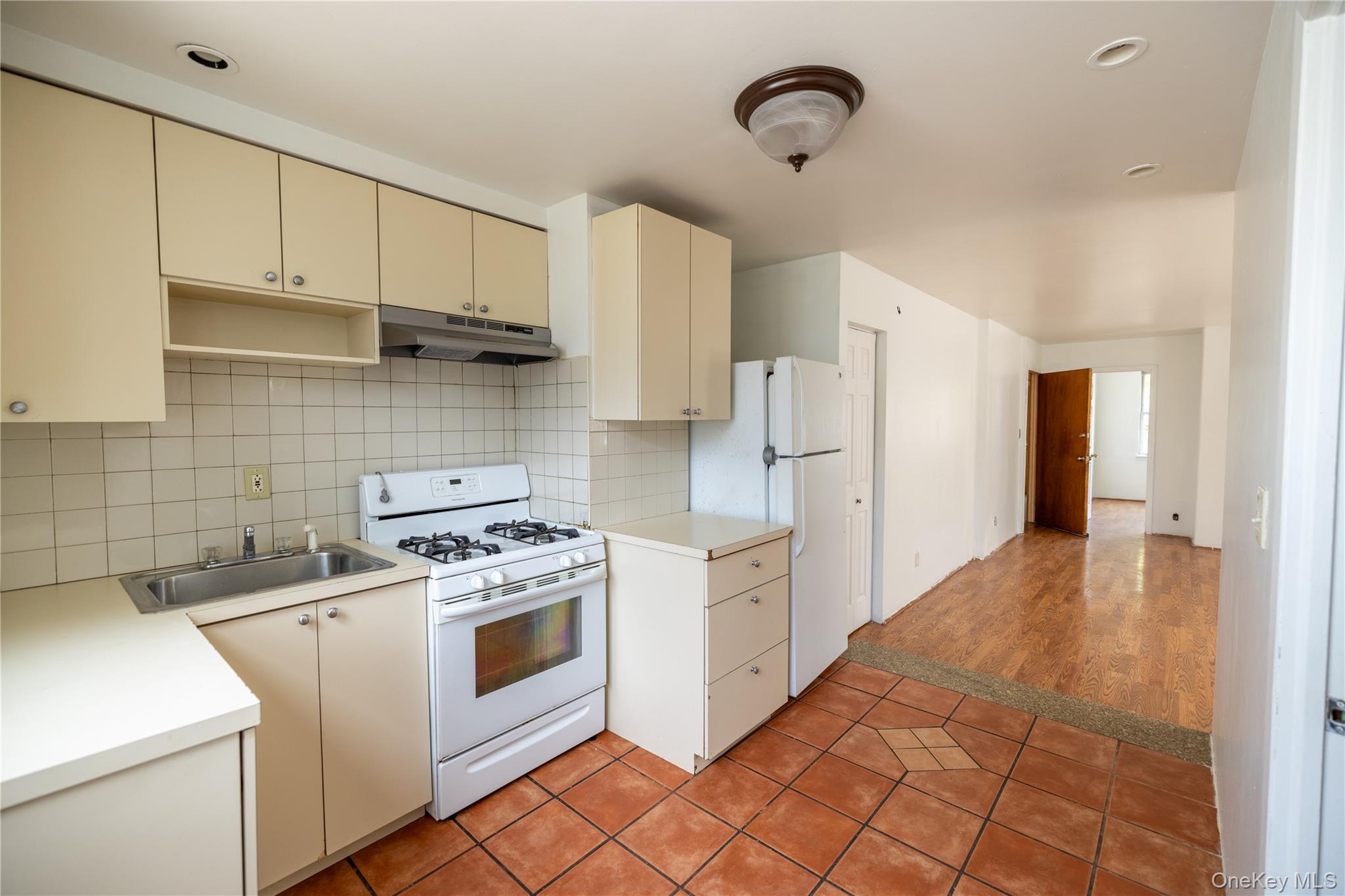2941 Middletown Road Bronx, NY 10461 - Photo 8 of 31 a kitchen with a stove top oven sink and refrigerator