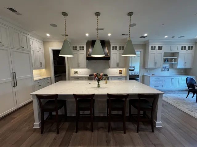a large kitchen with a table and chairs