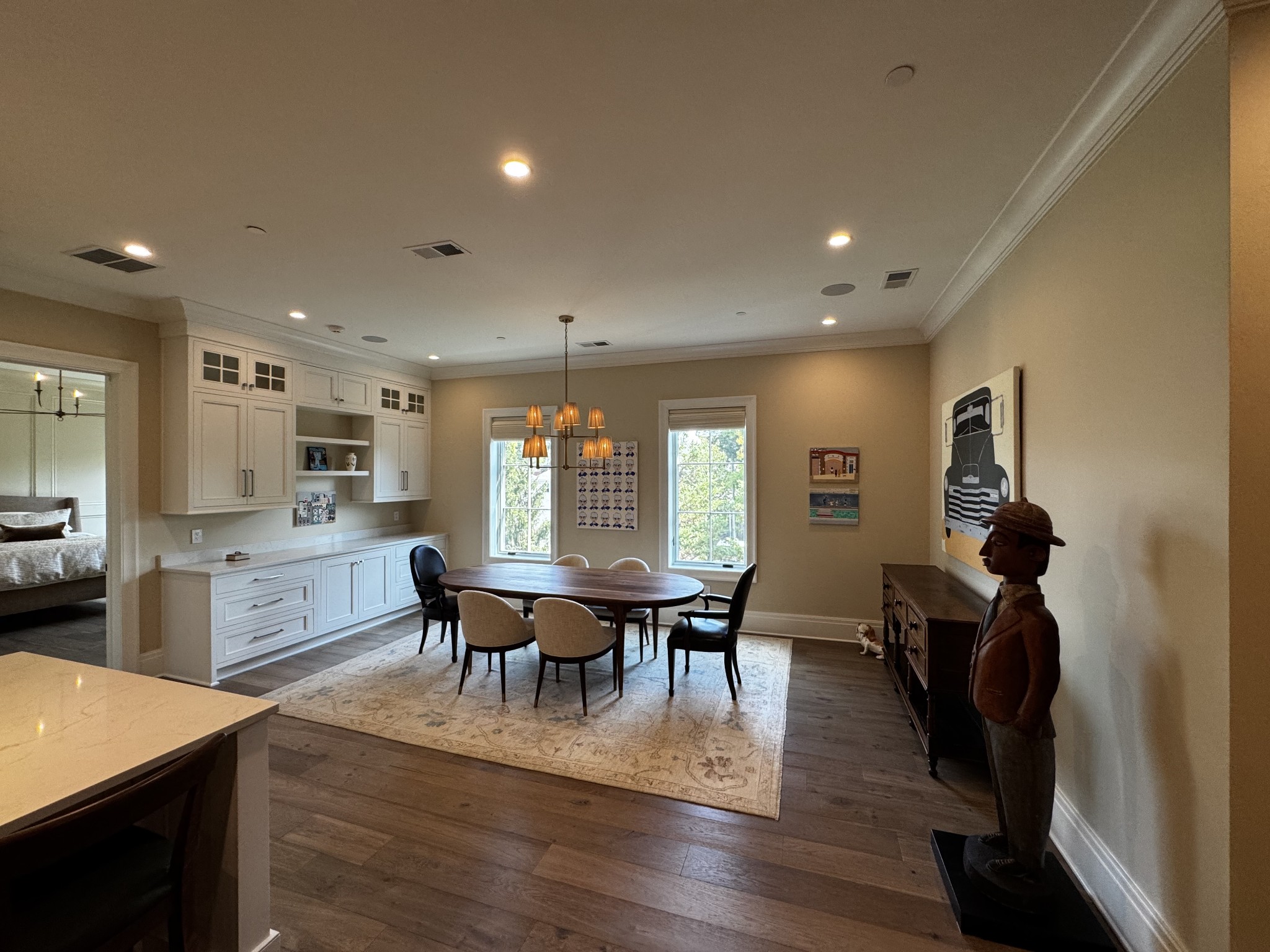 725 West Main Street, Unit 101 Franklin, TN 37064 - Photo 6 of 8 a view of dining room and livingroom with furniture wooden floor a rug a painting and a chandelier