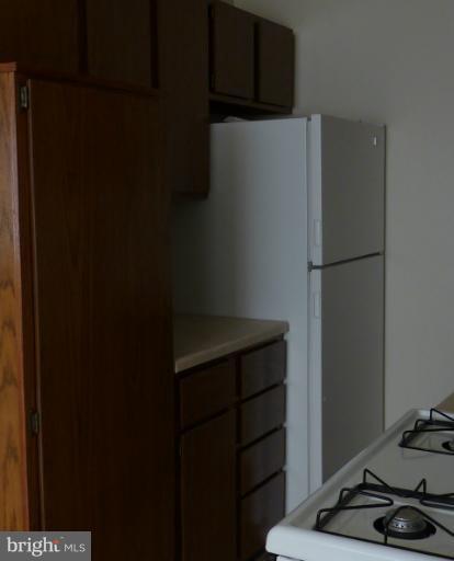 1200 South Arlington Ridge Road, Unit 315 Arlington, VA 22202 - Photo 5 of 12 a white refrigerator freezer and a stove sitting inside of a kitchen