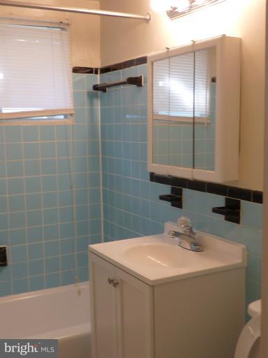 1200 South Arlington Ridge Road, Unit 315 Arlington, VA 22202 - Photo 7 of 12 a bathroom with a sink and a mirror