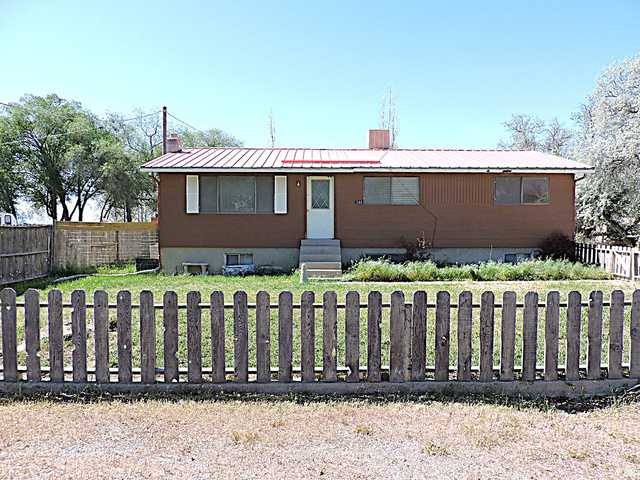 264 East 400 N Road Hinckley, UT 84635 - Photo 1 of 1 Single-story residence featuring a brown exterior siding and a red metal roof