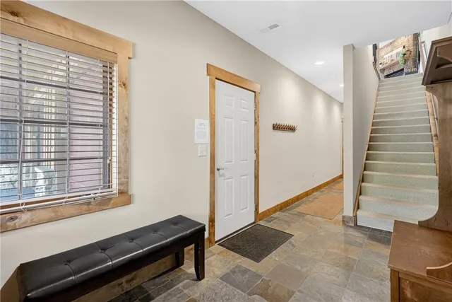 a view of a kitchen with furniture and wooden floor