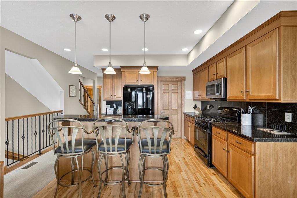 116 Lakeside Trail Champion, PA 15622 - Photo 12 of 44 a kitchen with stainless steel appliances kitchen island granite countertop a stove a sink and a refrigerator