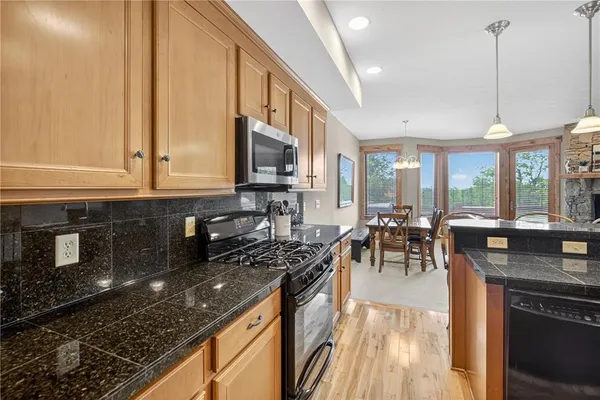 a kitchen with stove a sink and refrigerator