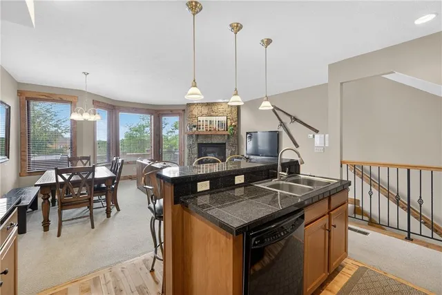 a kitchen with a table chairs refrigerator and microwave