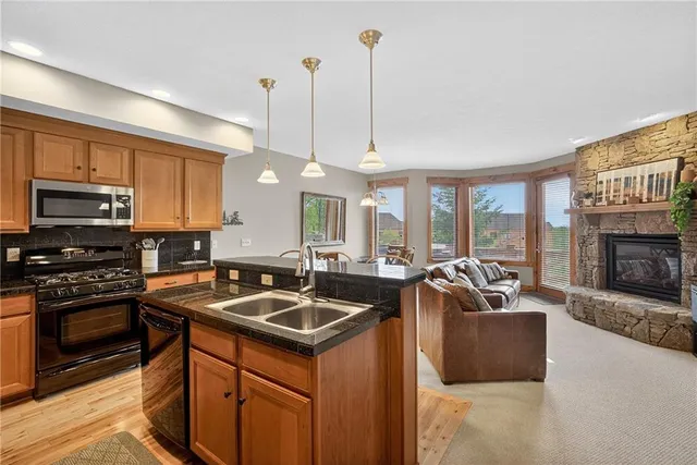 a kitchen with a refrigerator a sink a stove and cabinets