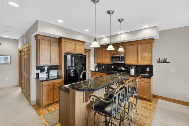 a living room with furniture a fireplace and a large window