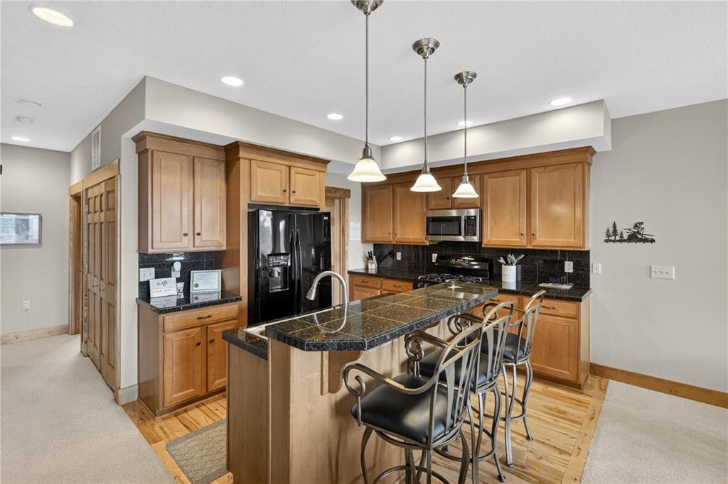 116 Lakeside Trail Champion, PA 15622 - Photo 18 of 44 a kitchen with a table chairs refrigerator and microwave