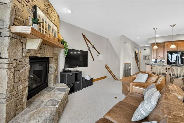 a dining room with furniture a chandelier and wooden floor