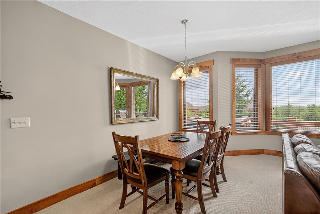 116 Lakeside Trail Champion, PA 15622 - Photo 25 of 44 a dining room with furniture a chandelier and wooden floor