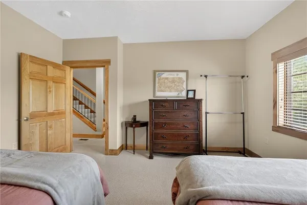 a spacious bedroom with a bed and a fireplace