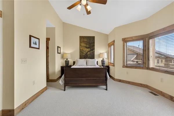 a bedroom with a bed and lamp