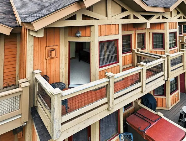 a view of a house with pool and wooden fence