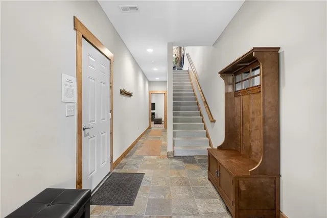 a kitchen with stainless steel appliances kitchen island granite countertop a stove a sink and a refrigerator