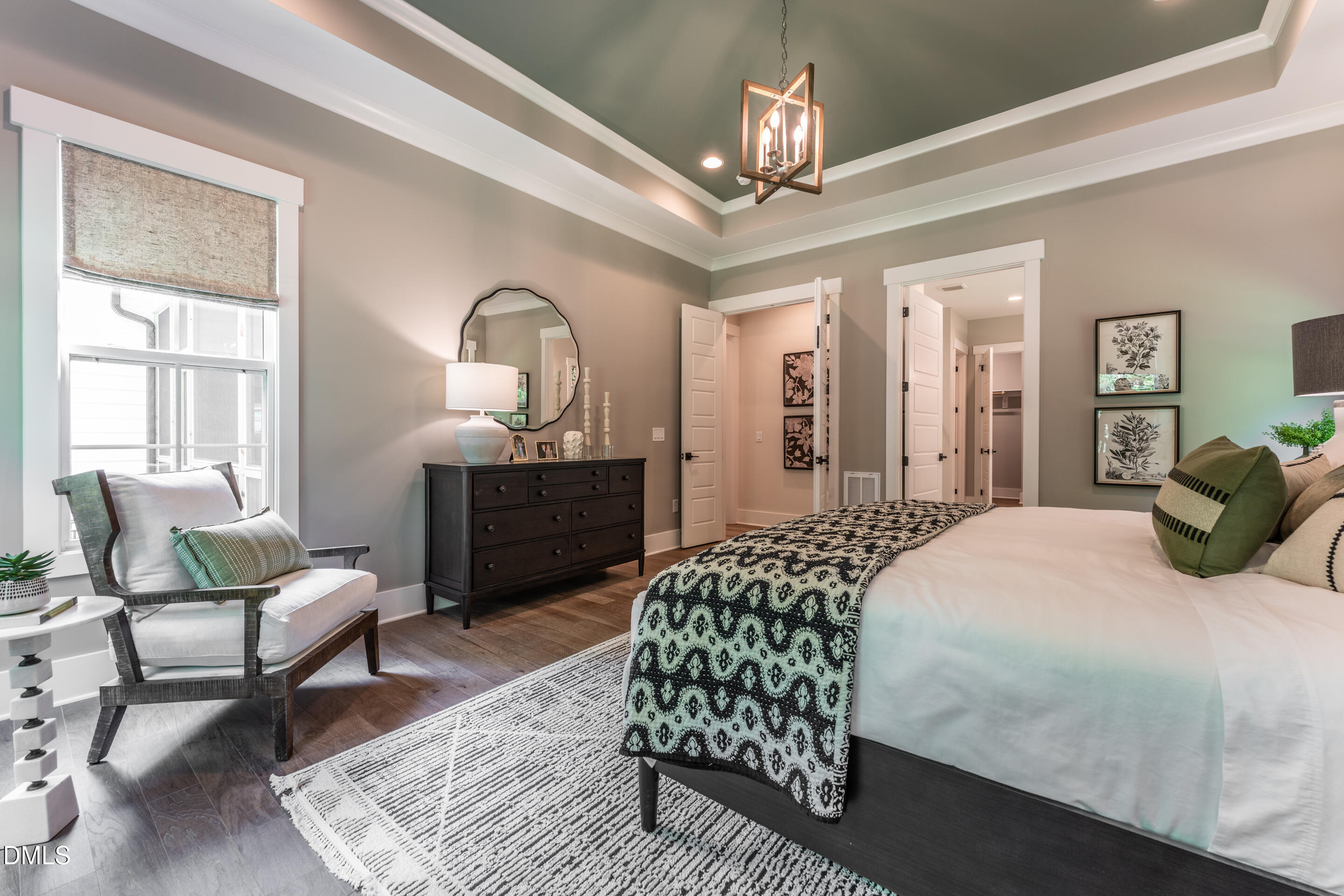 247 Ivy Rdg Road Chapel Hill, NC 27516 - Photo 29 of 70 a bedroom with a bed wooden floor and a chandelier