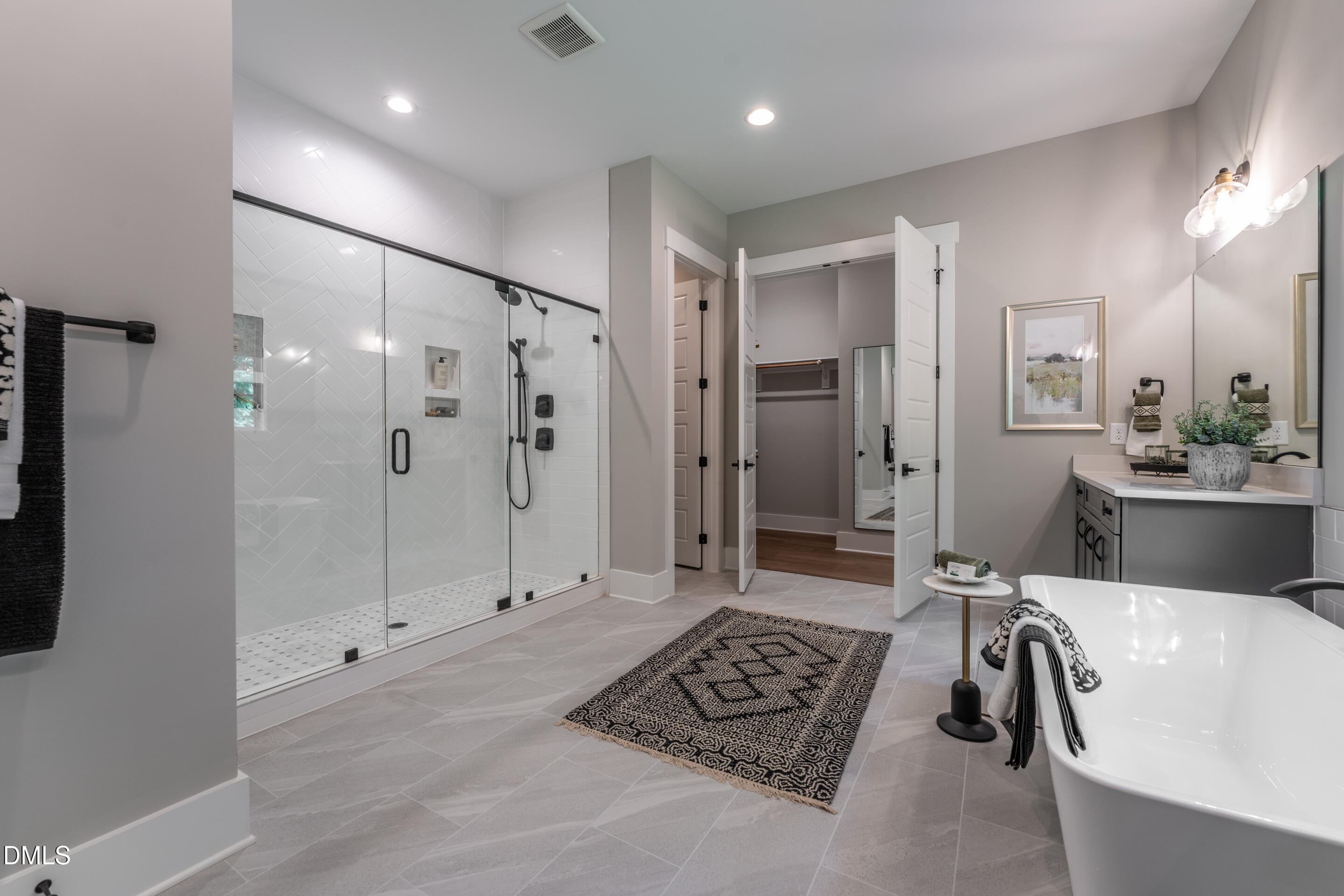 247 Ivy Rdg Road Chapel Hill, NC 27516 - Photo 31 of 70 a bathroom with a tub shower a sink and mirror
