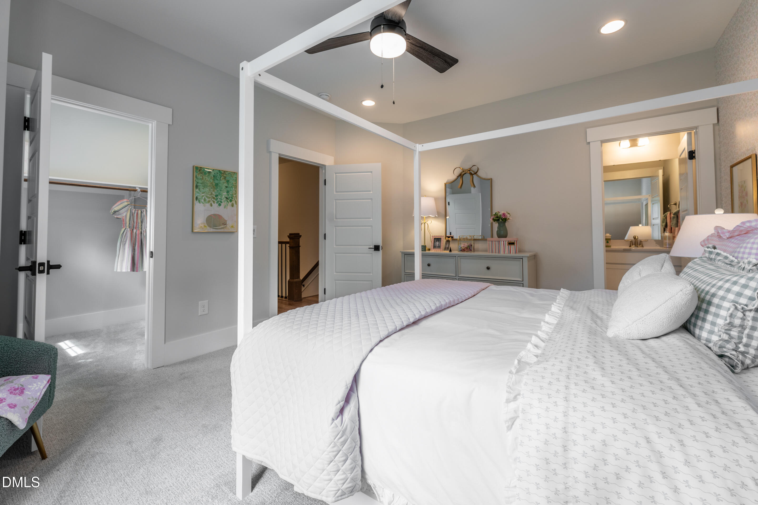 247 Ivy Rdg Road Chapel Hill, NC 27516 - Photo 43 of 70 a spacious bedroom with a bed and a chandelier