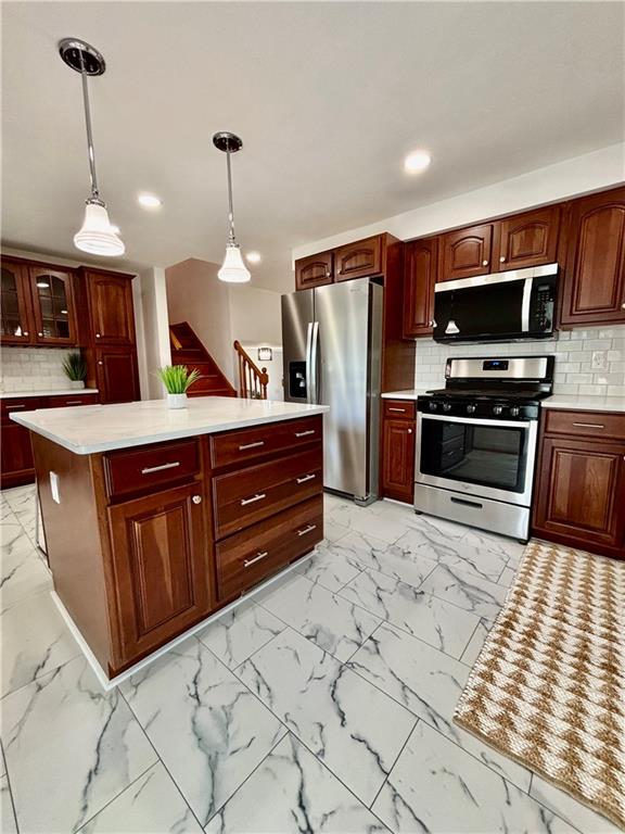 14190 Ridge Road Irwin, PA 15642 - Photo 16 of 49 a kitchen with stainless steel appliances granite countertop a refrigerator a oven a sink a stove and a wooden floors