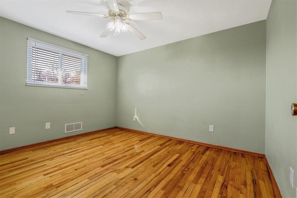 14190 Ridge Road Irwin, PA 15642 - Photo 23 of 49 a view of an empty room with wooden floor and a window