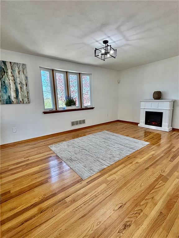 14190 Ridge Road Irwin, PA 15642 - Photo 6 of 49 a view of an empty room with window and wooden floor