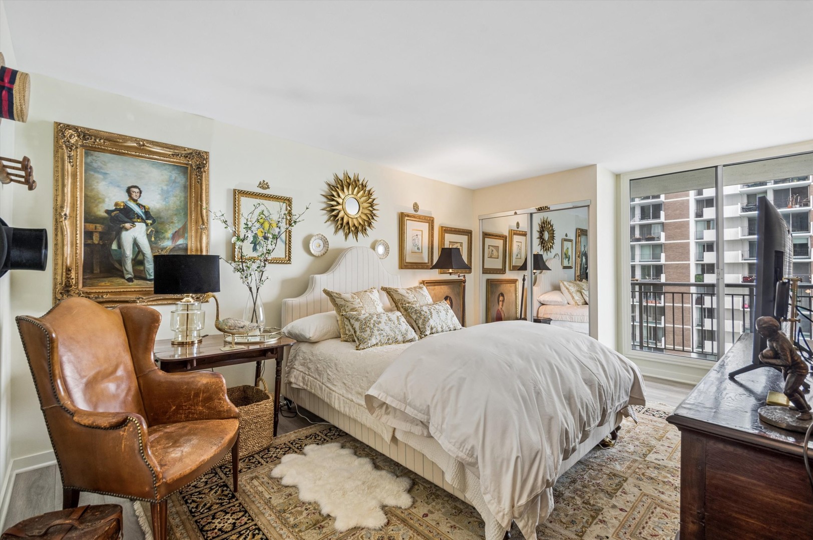 6007 North Sheridan Road, Unit 15B Chicago, IL 60660 - Photo 12 of 18 a bedroom with a bed a couch and a large window