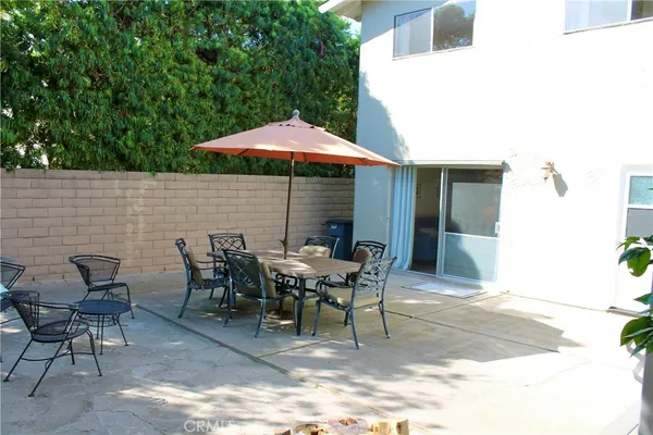 a patio with table and chairs