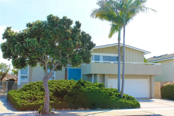 front view of a house with a garden