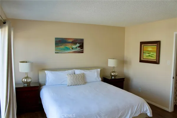 a bedroom with a bed and wall painting