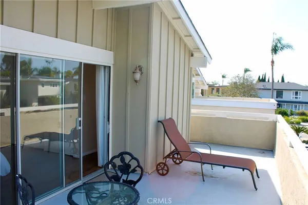 a balcony with table and chairs