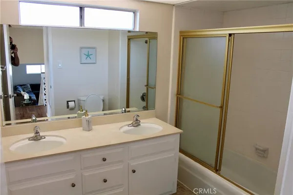 a bathroom with a double vanity sink and a mirror