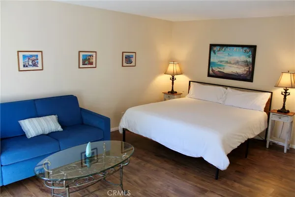 a bedroom with bed and a couch