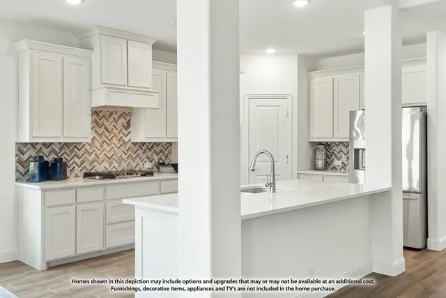 a kitchen with a table and chairs