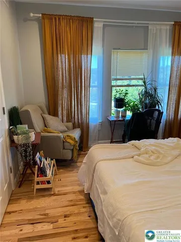 a bedroom with bed and a window