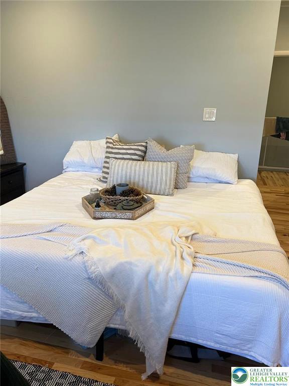 623 Walnut Street, Unit C2 Easton, PA 18042 - Photo 12 of 26 a bedroom with a bed and a chair