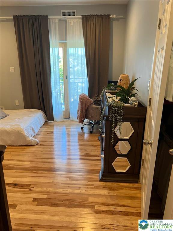 623 Walnut Street, Unit C2 Easton, PA 18042 - Photo 17 of 26 a bedroom with a bed and large windows